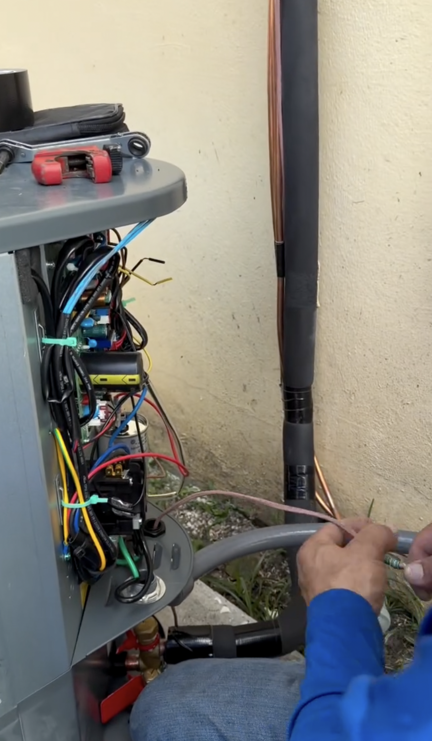 Rocket HVACR technician performing precision wiring on an HVAC system